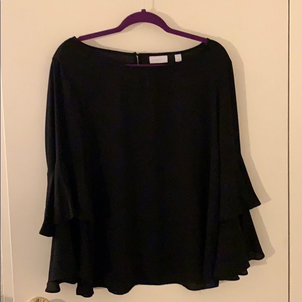Cute black shirt with 3/4 length ruffle sleeves.